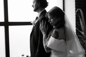 young couple bride and groom in a white dress photo