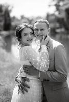 bride in a light wedding dress to the groom in a blue suit photo