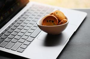 internet cookies internet browser cookies concept, mini cookies on keyboard computer laptop photo