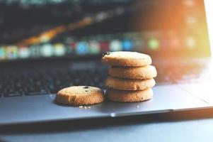 internet cookies internet browser cookies concept, mini cookies on keyboard computer laptop photo