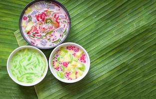 Thai dessert - Thai rice flour pandan leaf cantaloupe jelly mixed fruit with coconut milk and syrup sweets dessert on bowl, Asian food photo