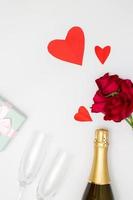Festive party concept, Champagne and rose on the table with glass cutlery and gift box for dinner photo
