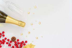 Christmas party concept, Champagne with glass and christmas decoration with holly berries and stars