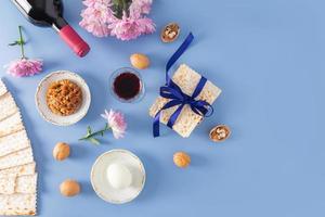 festive background of the Jewish Passover. traditional symbols and products of the holiday on a blue background. top view. flat layout. a copy space. photo