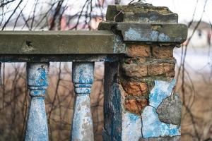 a balustrade on the railing of an old cracked staircase photo