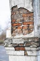 texture of old cracked and destroyed red brick wall photo