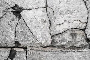 close up texture of cracked plaster on old house wall photo