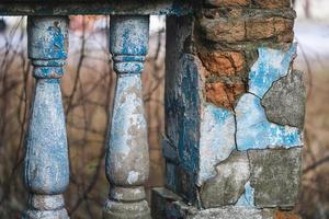 a balustrade on the railing of an old cracked staircase photo