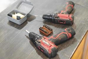 two electric screwdrivers or drills for screwing and drilling photo