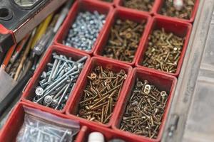 many different screws in the  organizer of master for work photo