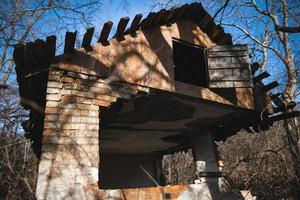 old ruined house, not suitable for living, fallen brick wall photo