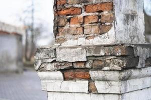 texture of old cracked and destroyed red brick wall photo