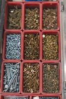 many different screws in the  organizer of master for work photo