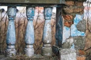 a balustrade on the railing of an old cracked staircase photo