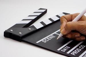 Focus the hand is holding clapperboard or movie slate black color and marker pen. Cinema industry concept. photo