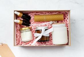 Gift box with candle making tools, candle, soy wax, wicks and aroma oil bottles photo