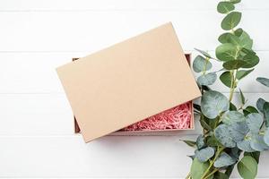 Shredded pink paper packing material texture in a craft box, mockup design photo