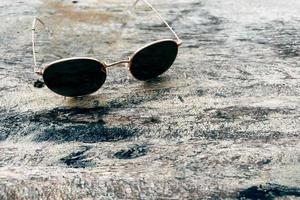 Sunglasses on wooden table summer concept background photo