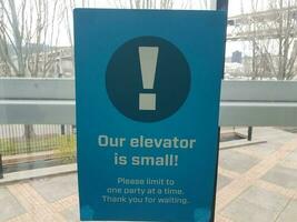 our elevator is small sign covid warning sign photo