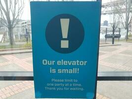 our elevator is small sign covid warning sign photo