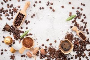 Background of various coffee , dark roasted coffee beans , ground and capsules with scoops setup on white concrete background with copy space. photo