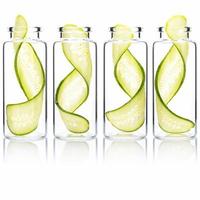 Homemade skin care cucumber slice twist in glass bottles isolated on white background. photo