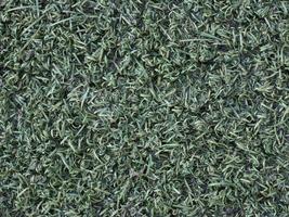 background with wet green synthetic grass texture photo