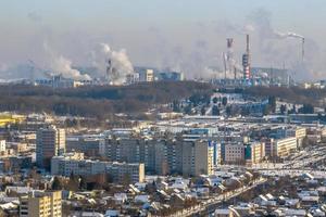 panoramic aerial view of the smoke of pipes as background of huge residential complex with high-rise buildings and private sector . Air and water pollution concept photo