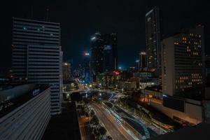 Night cityscape,and traffic light of highway in slow speed shutter motion effect and noise.Jakarta, Indonesia .January 9 2023 photo