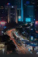 Night cityscape,and traffic light of highway in slow speed shutter motion effect and noise.Jakarta, Indonesia .January 9 2023 photo