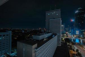 Night cityscape,and traffic light of highway in slow speed shutter motion effect and noise.Jakarta, Indonesia .January 9 2023 photo