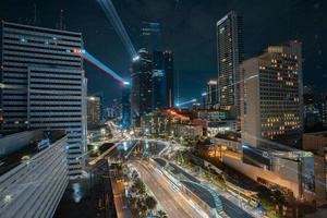 Night cityscape,and traffic light of highway in slow speed shutter motion effect and noise.Jakarta, Indonesia .January 9 2023 photo