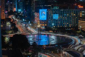 Night cityscape,and traffic light of highway in slow speed shutter motion effect and noise.Jakarta, Indonesia .January 9 2023 photo