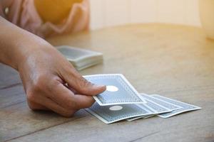 Card playing of elderly people at home in their freetimes, recreation and happiness of elderly people concept. photo