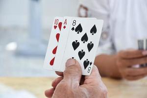 Card playing of elderly people at home in their freetimes, recreation and happiness of elderly people concept. photo