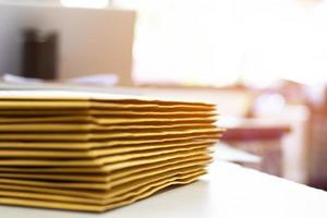 Soft focus of office clerk or secretary is preparing documents and brown envelopes for those interested in bidding for the construction of a large building in an office. photo