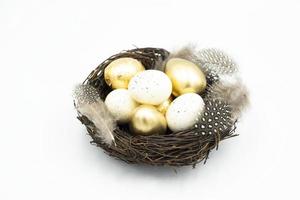 Nest, Easter golden and white eggs photo