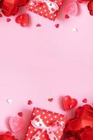 Gift box, candels and red heart shape baloons on pink background. Valentines Day concept photo