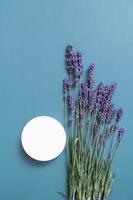 Podium, stage or pedestal with lavender flowers top view. Mock up for cosmetic products photo