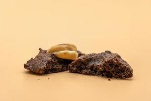 Dark Chocolate Cookies with raisin inside it on the light orange colour background. photo