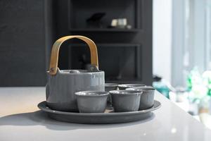 TeaPot ceramic set with New contemporary Modern and Vintage combination style on flat stone kitchen counter with sunlight from window. photo