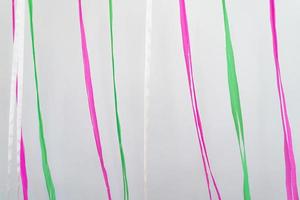 pink, green, white ribbons in vertical line background in minimal celebration event. photo