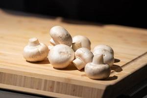 Straw mushroom is prepared on the wood board for ingredient of cooking. photo