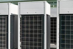 Compressors, air conditioners on the roof of the office building photo