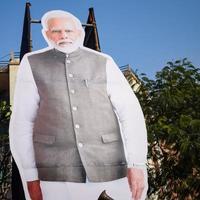New Delhi, India - January 16 2023 - Prime Minister Narendra Modi cut out during BJP road show, the status of PM Modi while attending a big rally in the capital photo
