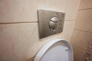 Push toilet flush press with two separate buttons. photo