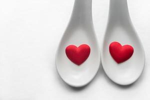 Red Heart shape in white spoon with copy space for text and design photo