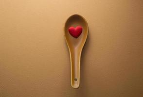 top view of Red Heart shape in spoon with copy space for text and graphics photo