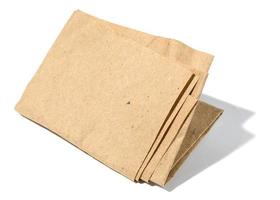 Piece of crumpled brown paper isolated on white background photo