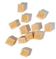 Cane sugar cubes on white background, top view photo